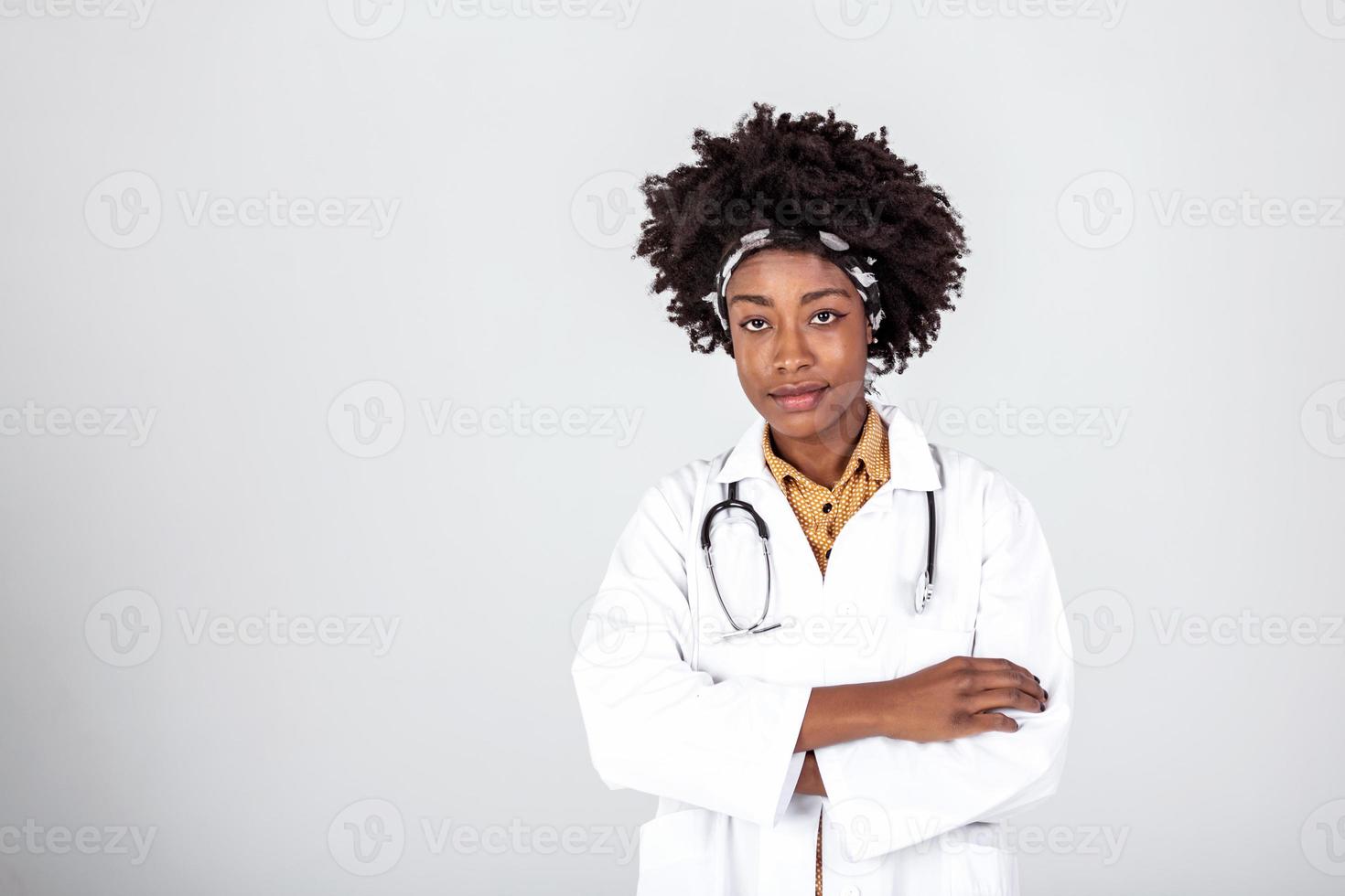 medicine, profession and healthcare concept - happy smiling african american female doctor in white coat with stethoscope over background photo