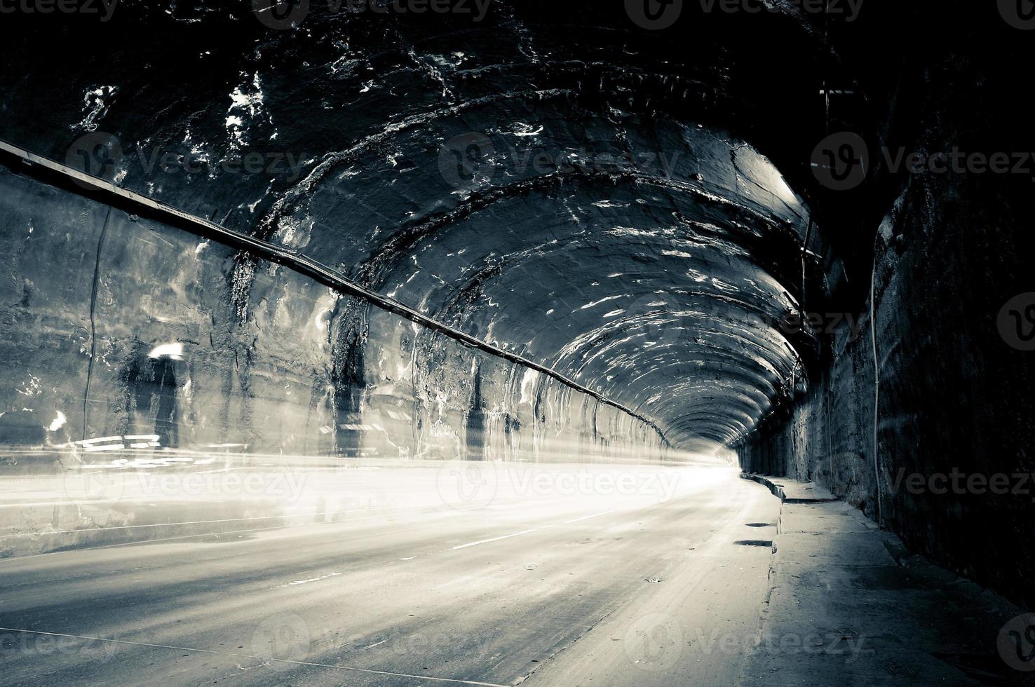 Dark tunnel with dim lights and trails. photo