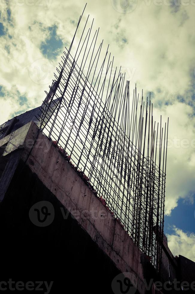 Part of an unfinished building construction with iron sticks. photo