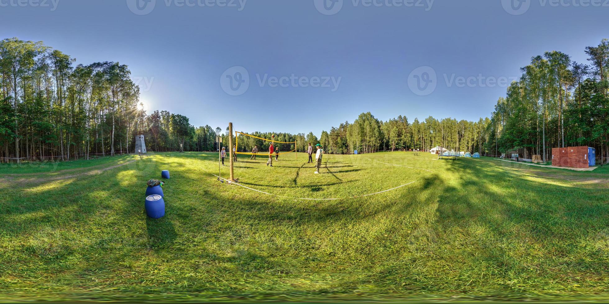 full seamless spherical hdr 360 panorama group of pioneers or boy scouts playing volleyball in forest camp with sports ground in equirectangular projection,  VR AR content photo