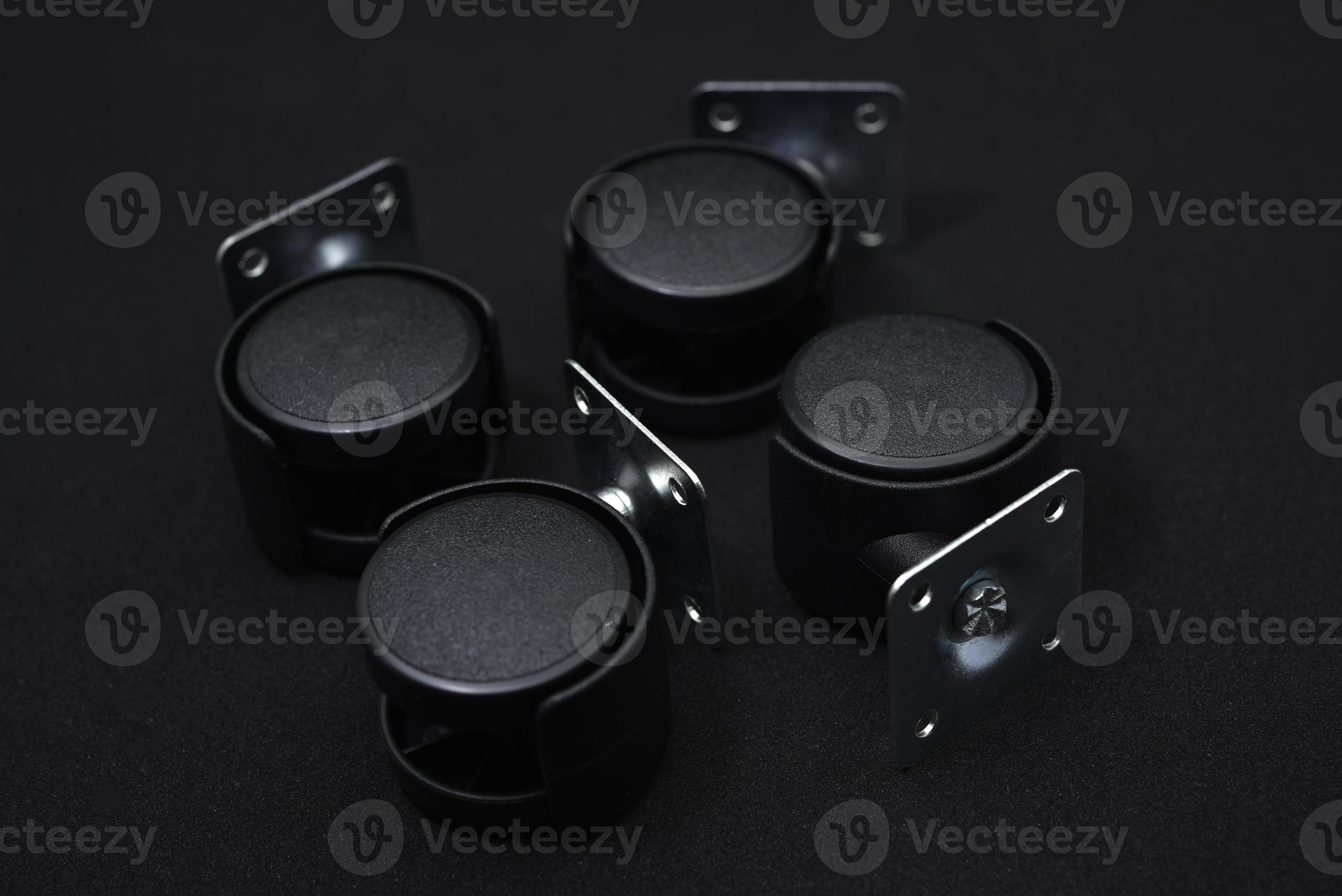 Black plastic furniture rollers on a black background. 21159659 Stock Photo  at Vecteezy