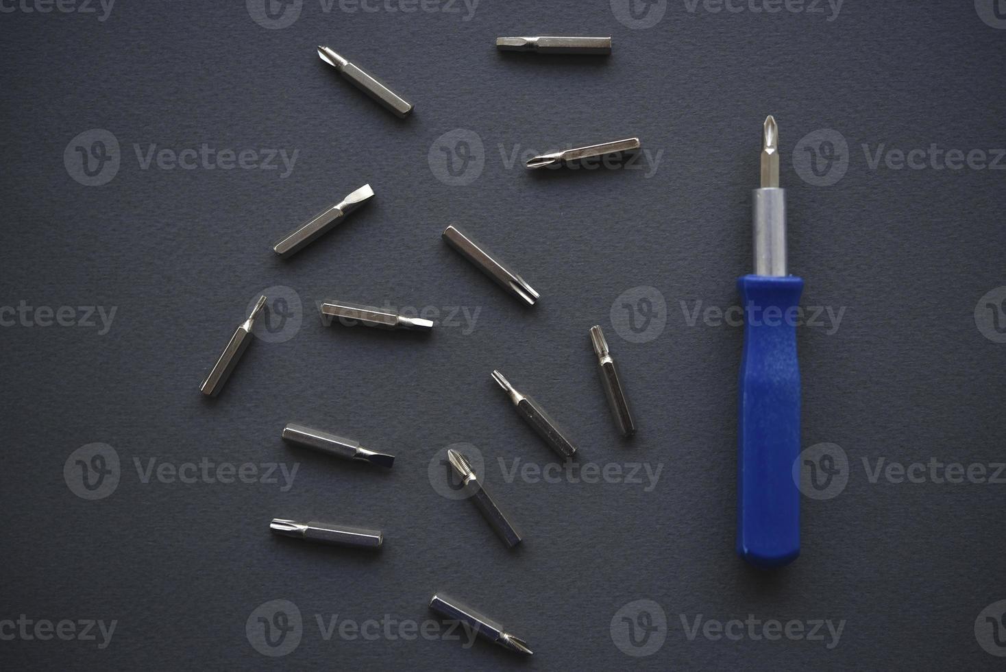 Replaceable nozzles for a screwdriver. Blue screwdriver with attachments. photo