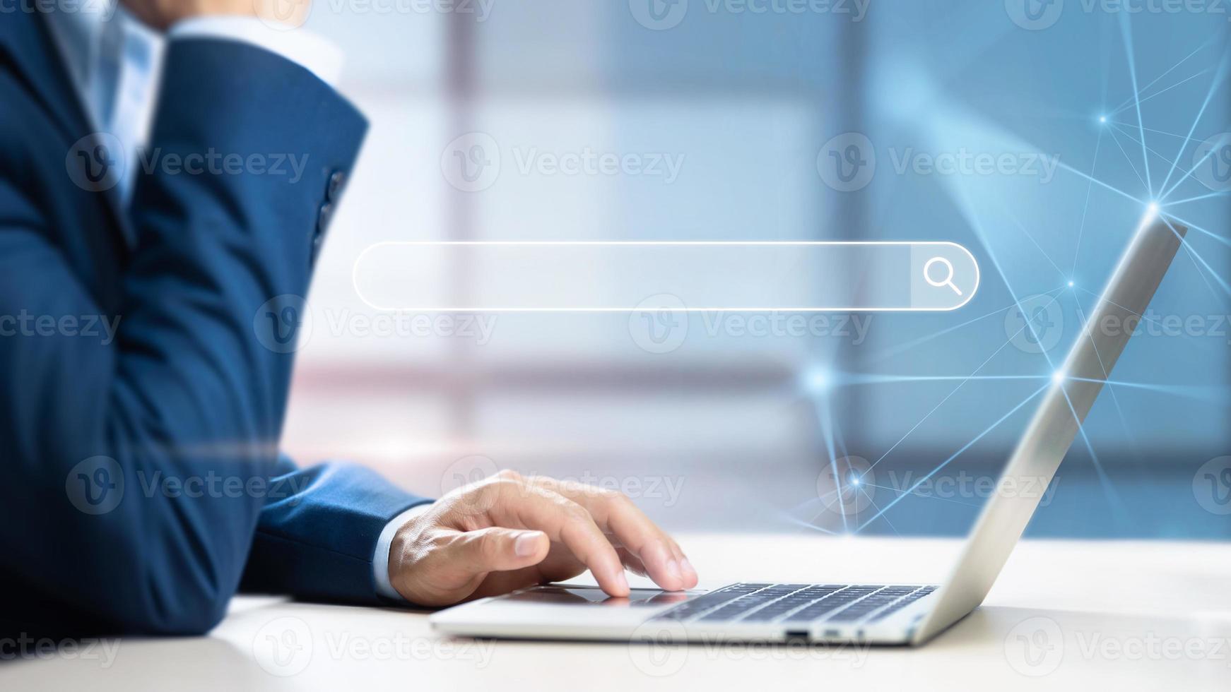 Businessman using computer searching information web browser webpage, Search Engine Optimization and Data Search Technology Concept, Internet network connecting online worldwide on office background photo