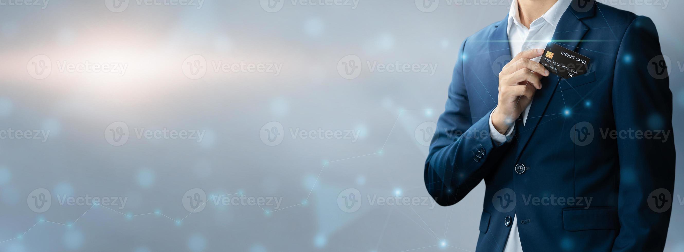 Businessman in blue suit put or take out credit card in pocket with copy space background, Technology digital future of business finance and payment online shopping concept, Handsome young in close up photo