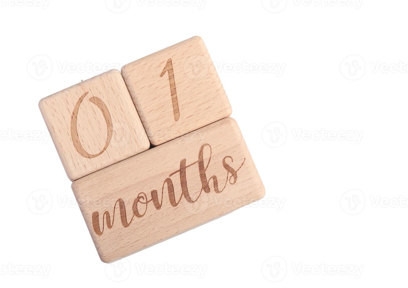 A wooden block showing the date of birth of a newborn child on a white background. photo