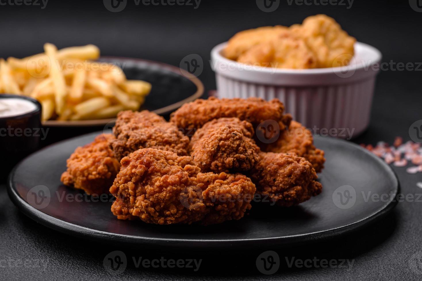 Delicious crispy breaded chicken wings grilled with spices and herbs photo