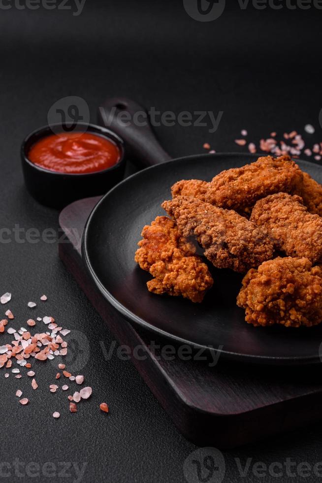 Delicious crispy breaded chicken wings grilled with spices and herbs photo