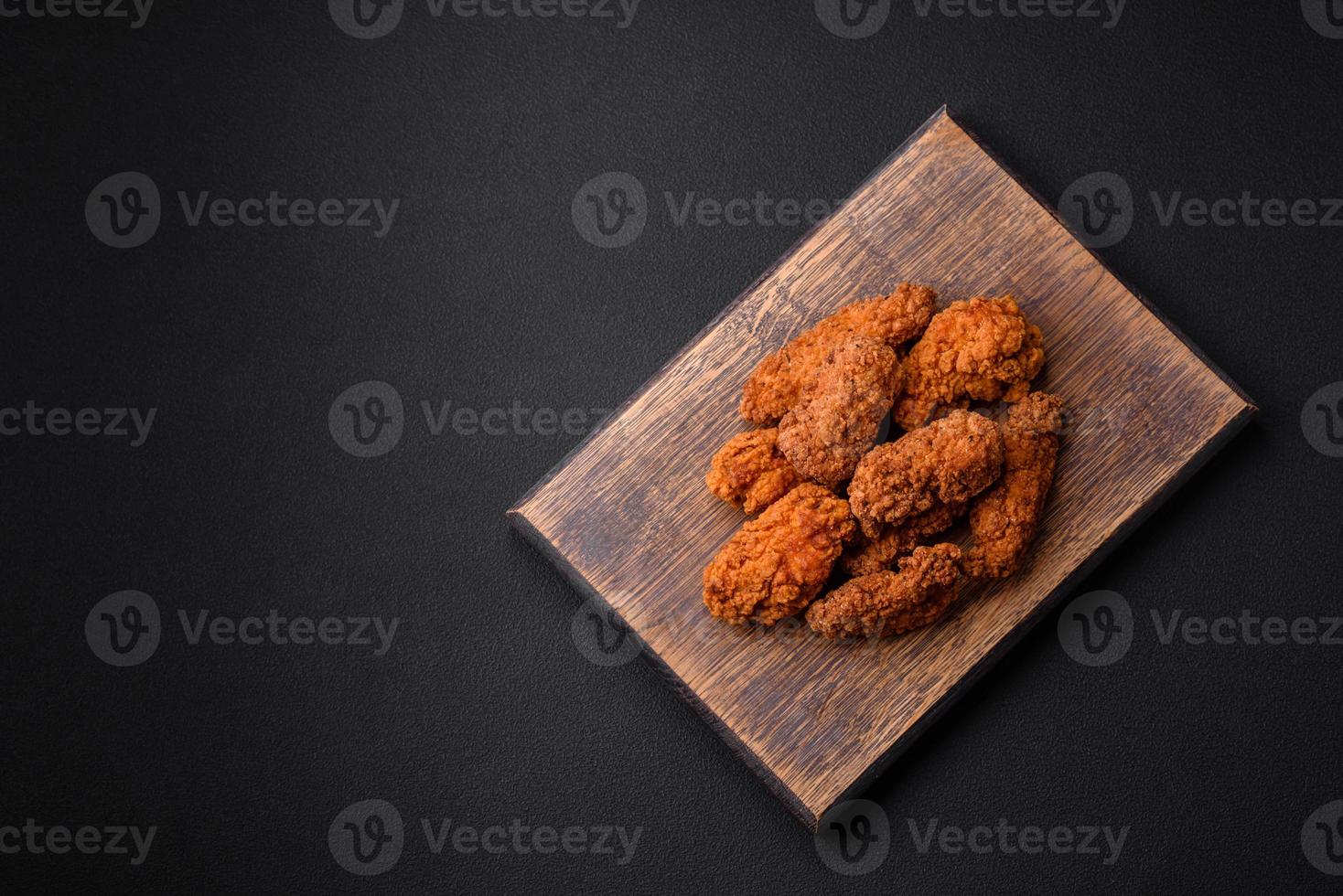 Delicious crispy breaded chicken wings grilled with spices and herbs photo