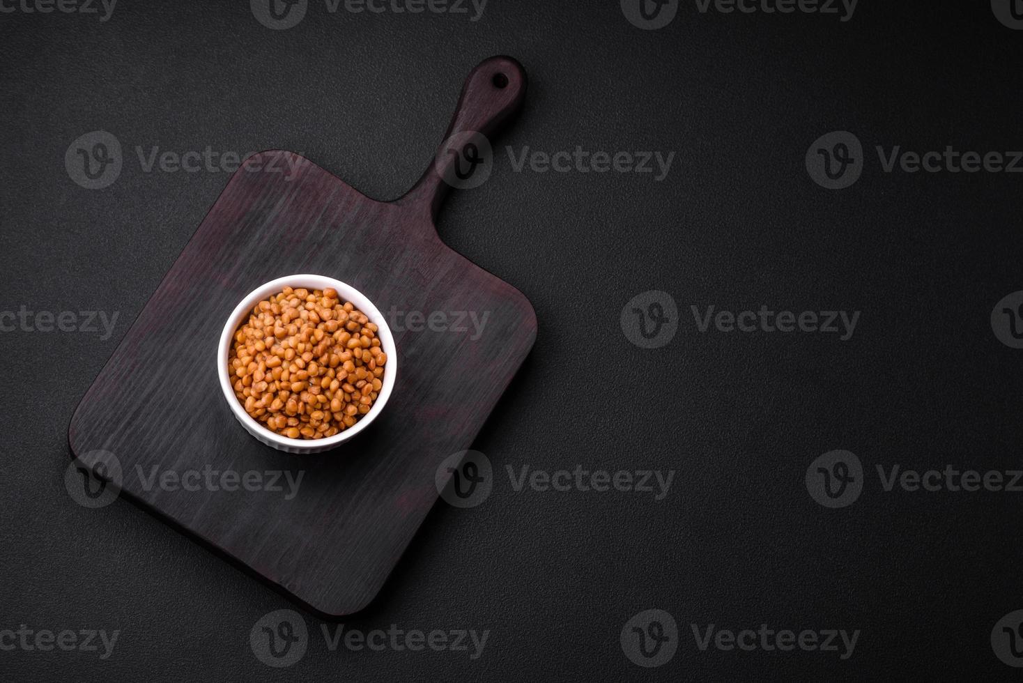 Delicious healthy canned lentils in a ceramic ribbed white bowl photo