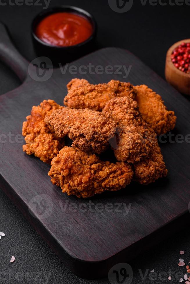 Delicious crispy breaded chicken wings grilled with spices and herbs photo