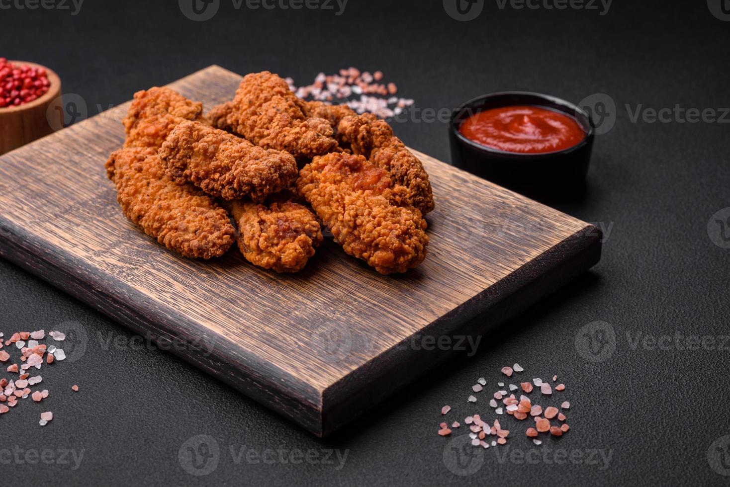 Delicious crispy breaded chicken wings grilled with spices and herbs photo