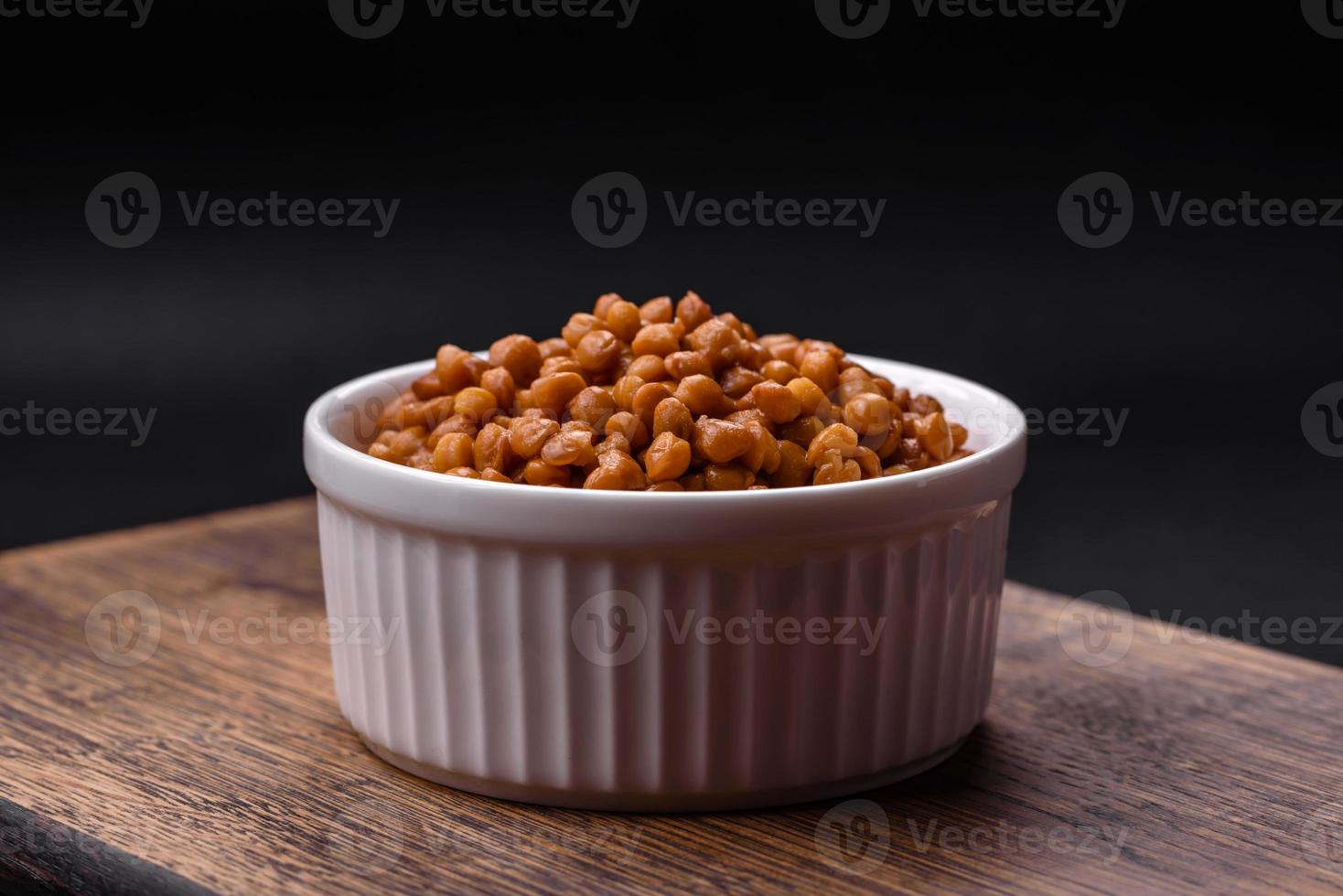 Delicious healthy canned lentils in a ceramic ribbed white bowl photo
