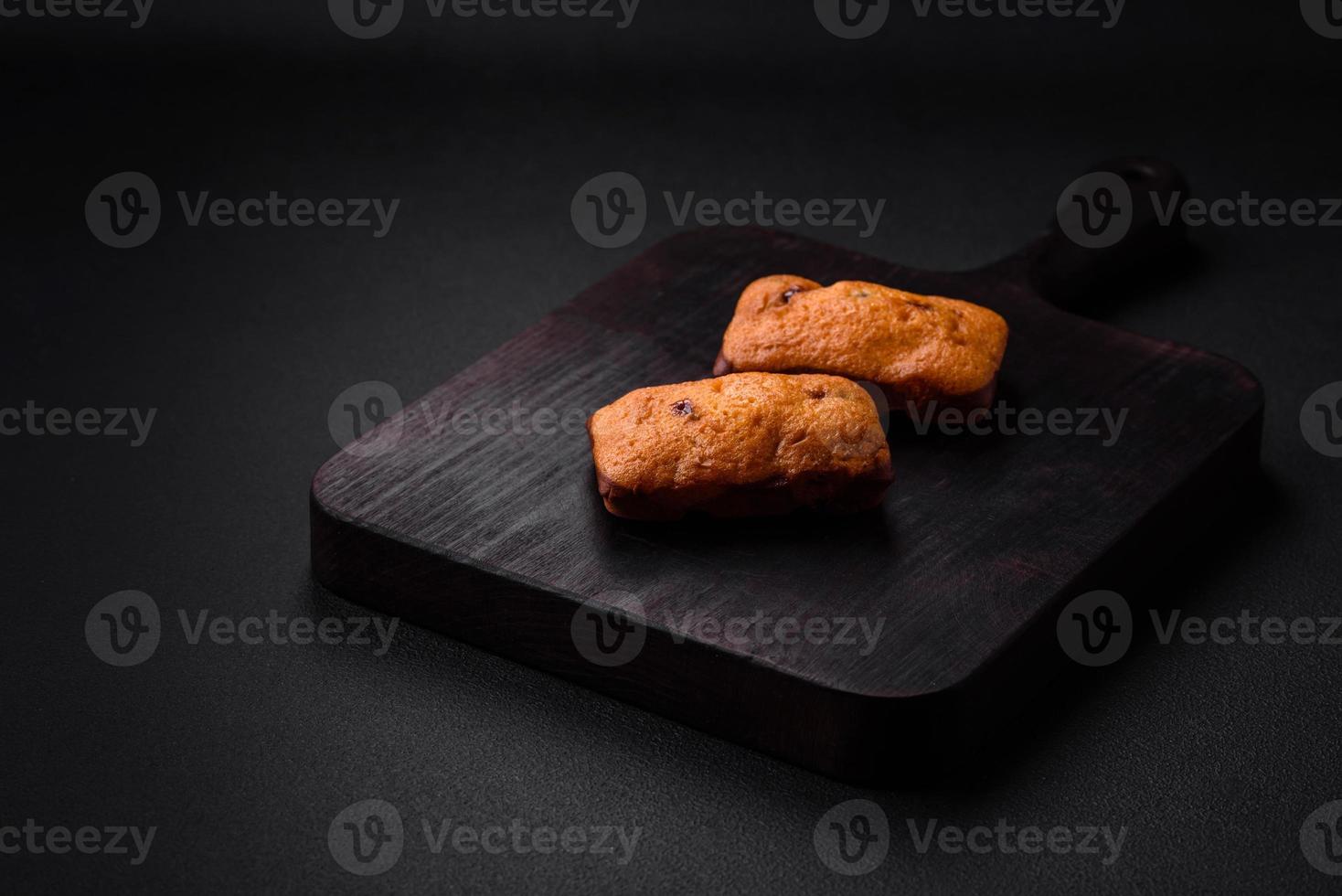 Delicious chocolate muffins and dried round shaped slices of tangerine photo