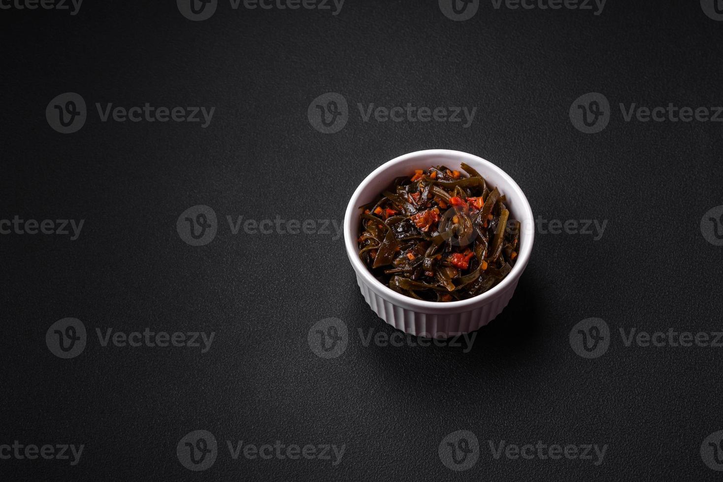 Delicious marinated seaweed with paprika, spices and salt photo