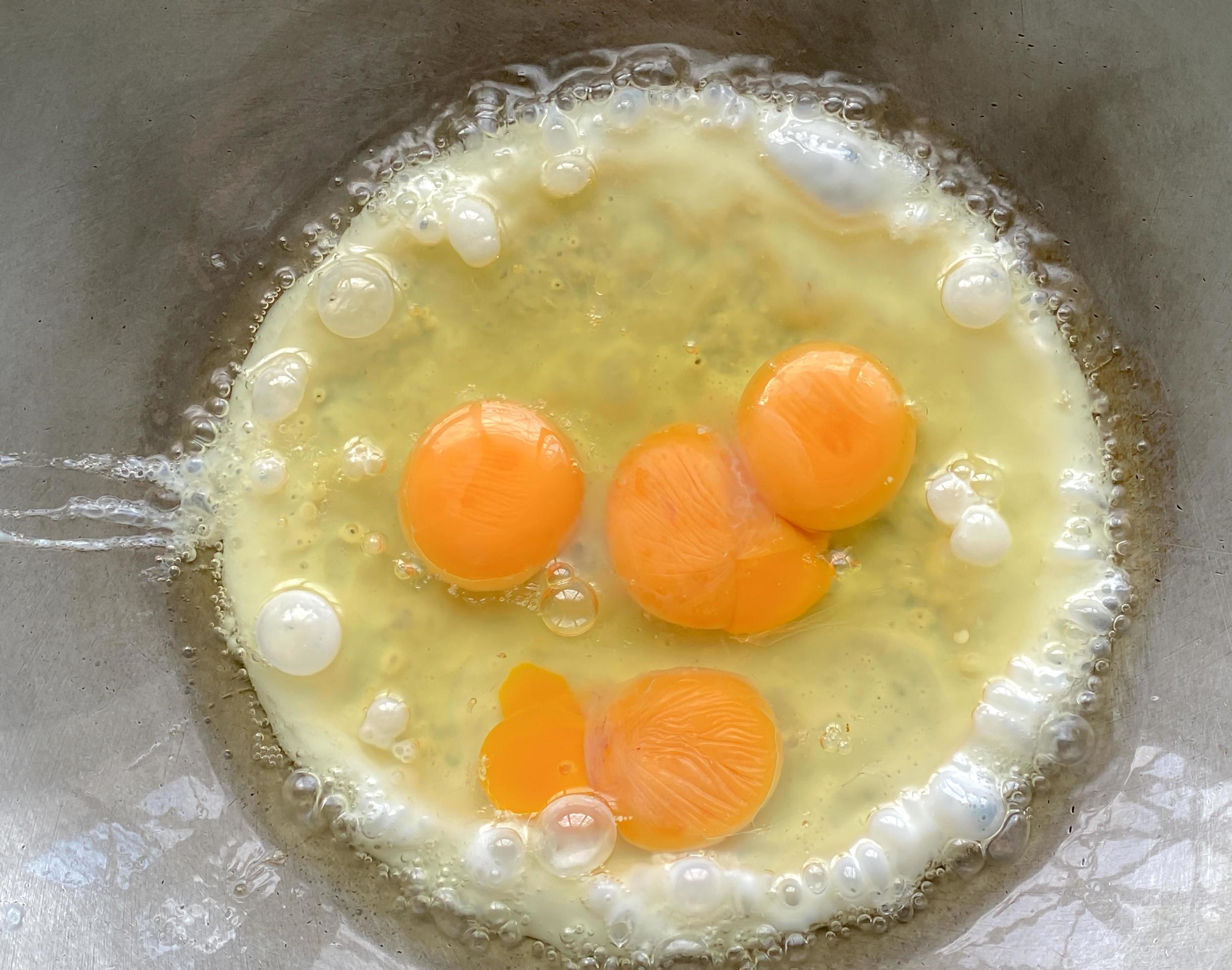 Fried eggs in a hot pan looks appetizing It's a simple breakfast. with