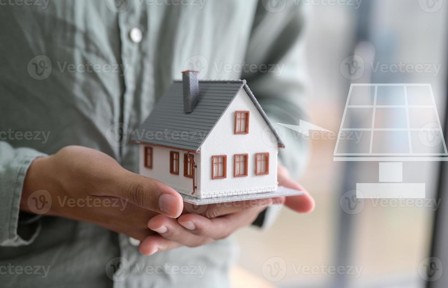Close-up shot of A person holding a model house in hand.For real estate concepts. photo