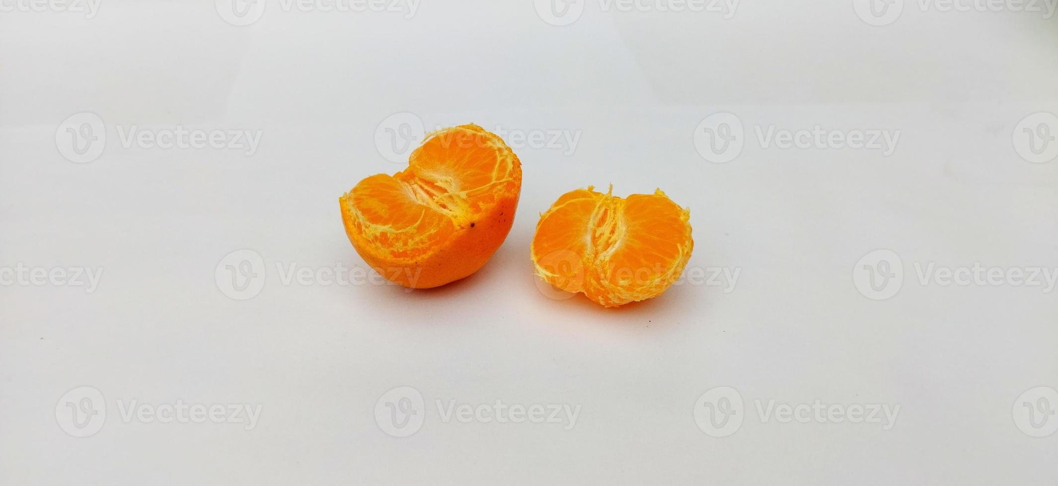 Peeled of Citrus sinensis, called jeruk baby santang with leaves isolated on white background. Local fresh fruit from Indonesia photo