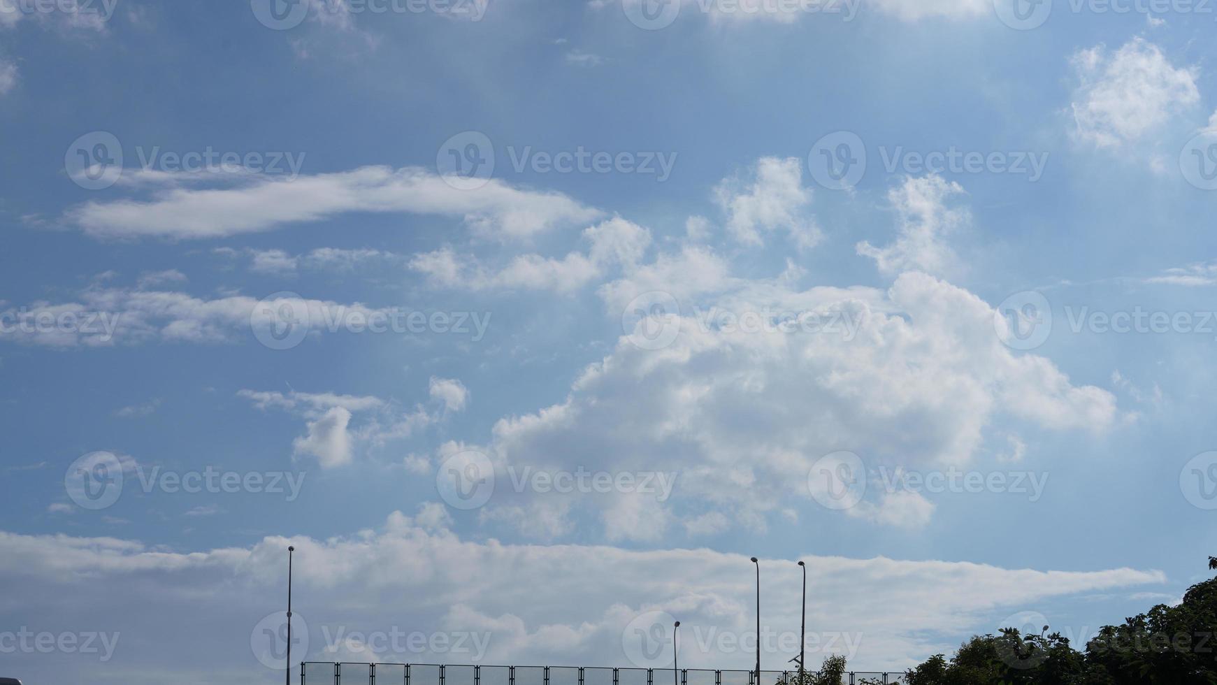 The summer sky view with the white clouds and blue sky as background photo