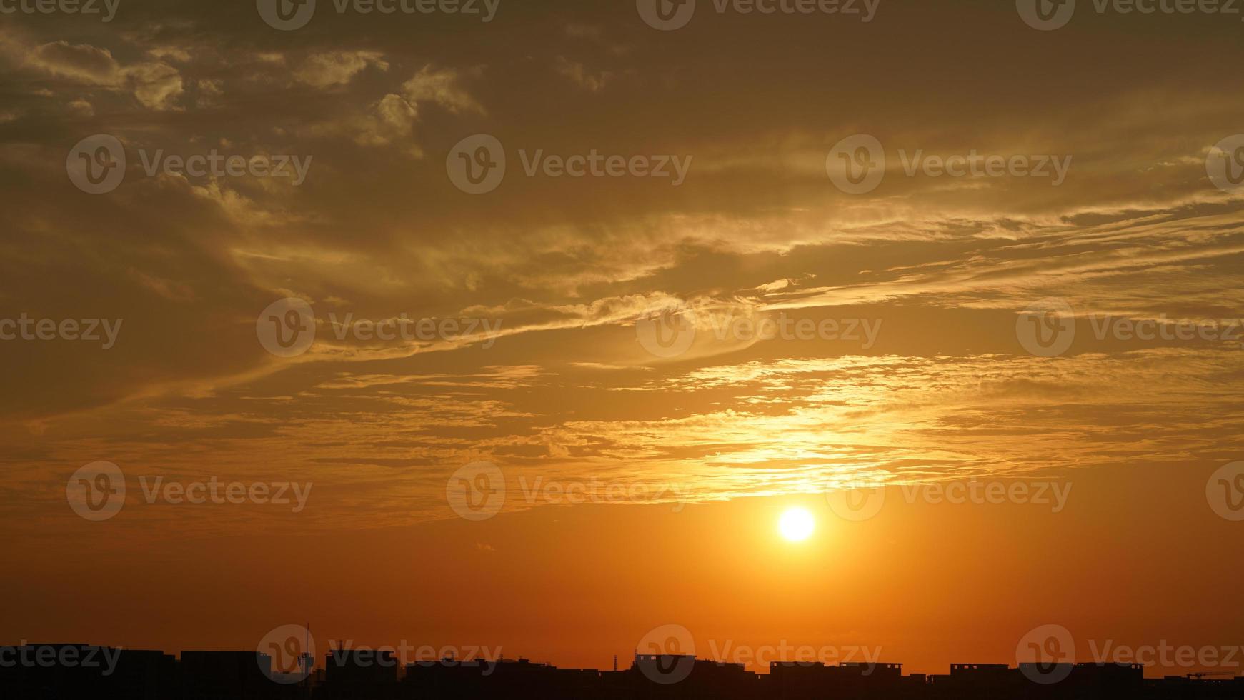 The beautiful sunset sky view with the colorful clouds and warm lights in the sky photo