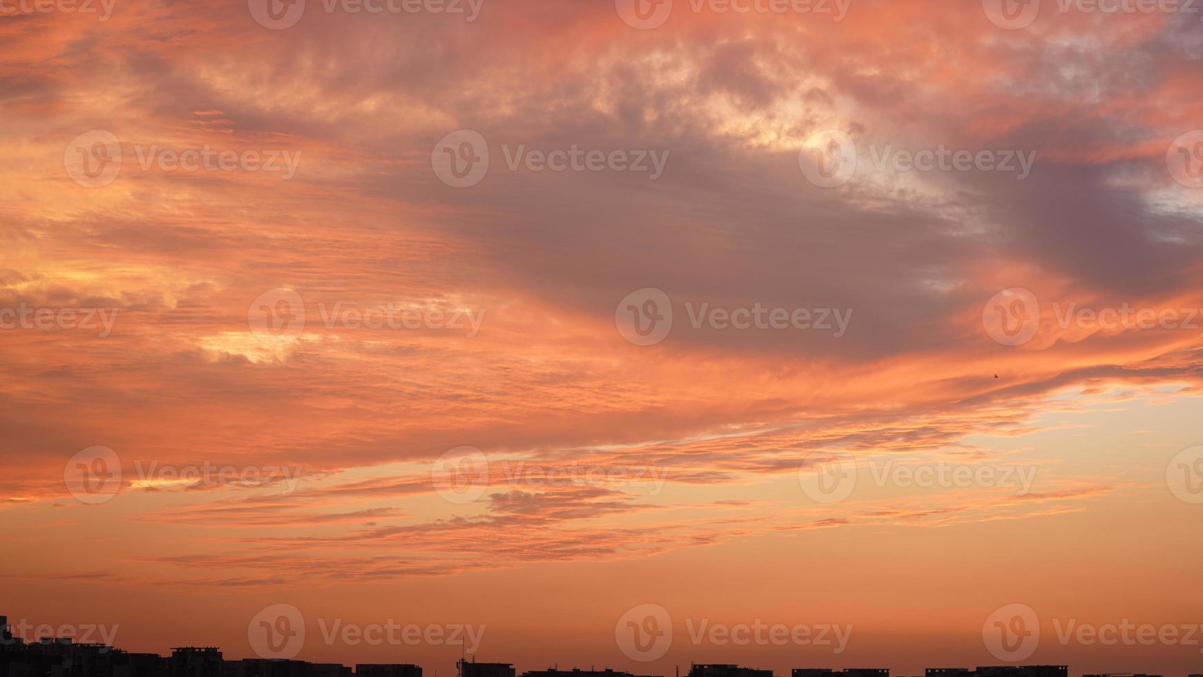 The beautiful sunset sky view with the colorful clouds and warm lights
