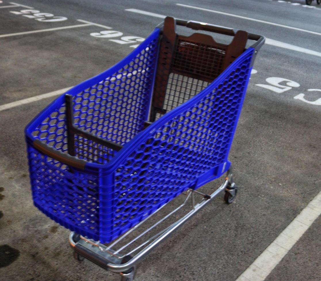 Plastic shopping carts in blue color on the road photo