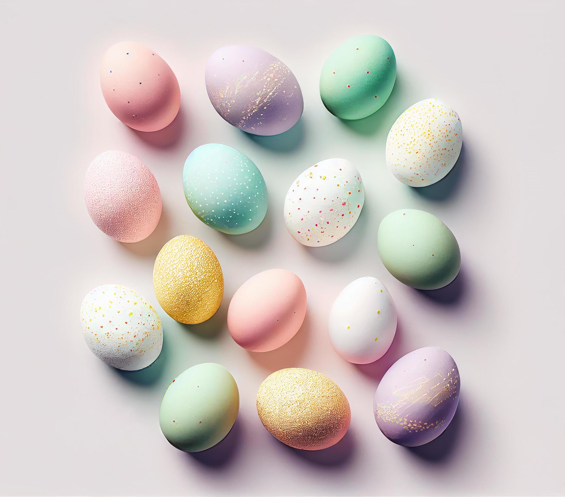 Top view of colorful pastel painted easter eggs on white background for