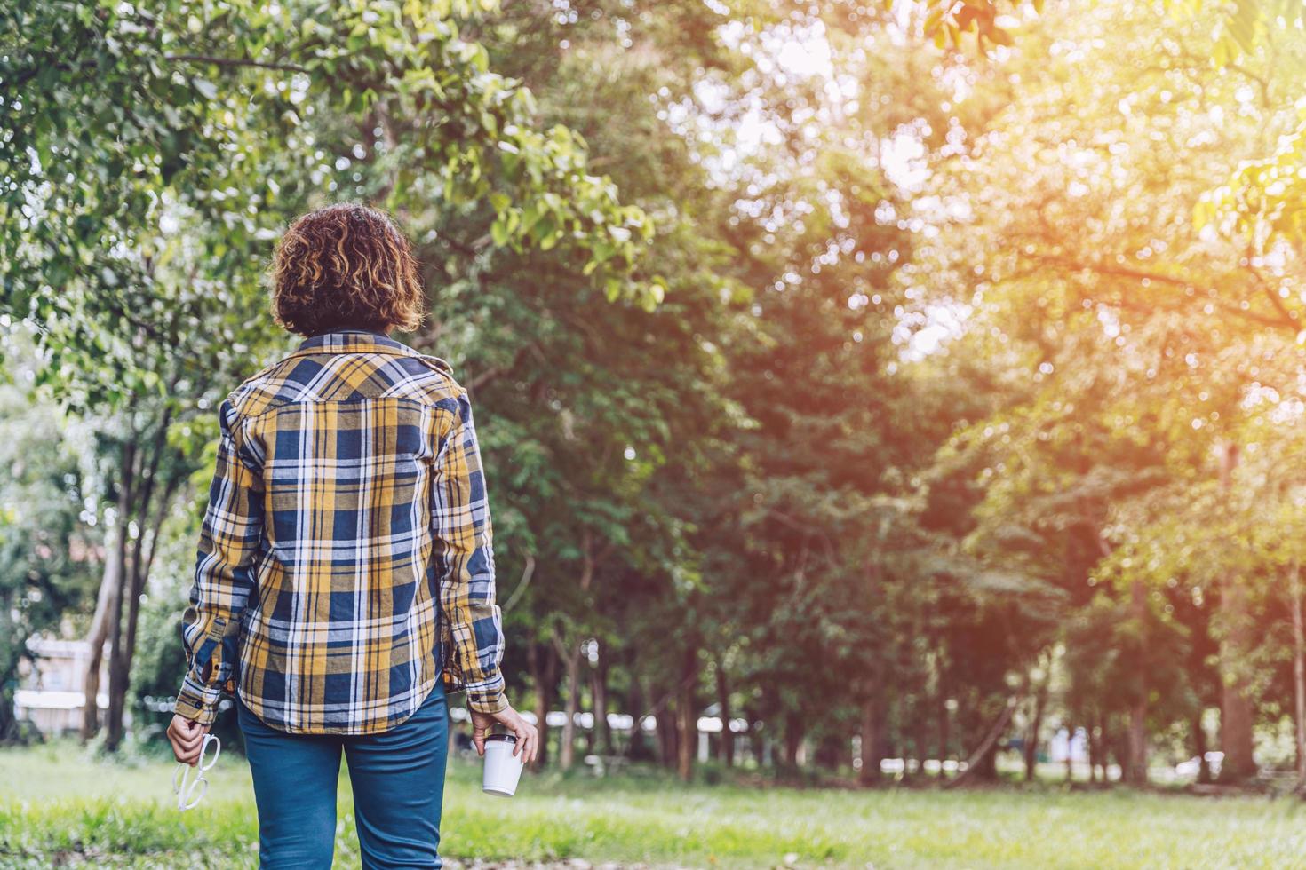 Asian woman walking in the garden photo