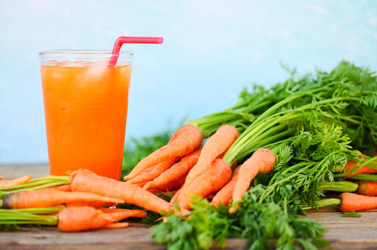 fresh and sweet carrot slices for cooking food fruits and vegetables for health concept, fresh carrots juice on glass with ice on summer, carrot juice on wooden table background photo