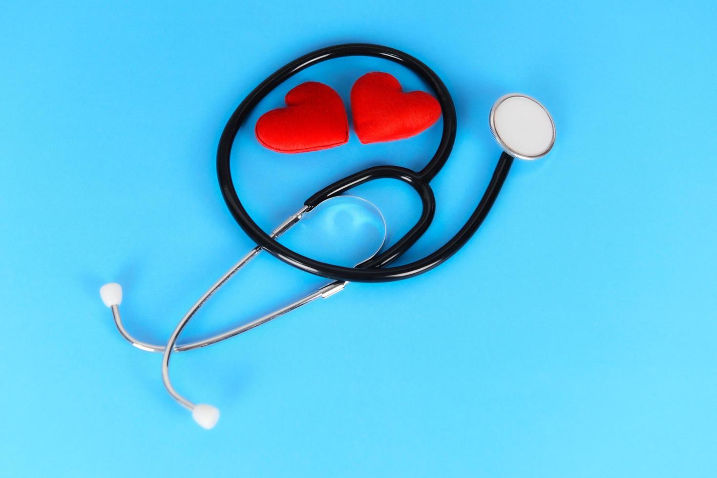 Insurance Health concept - Stethoscope and red heart healthcare on blue background photo