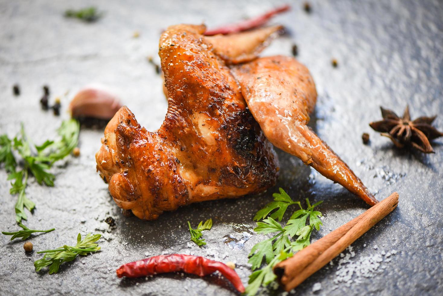 chicken wings grill with garlic chilli herbs and spices on black plate top view - Baked chicken wings BBQ photo