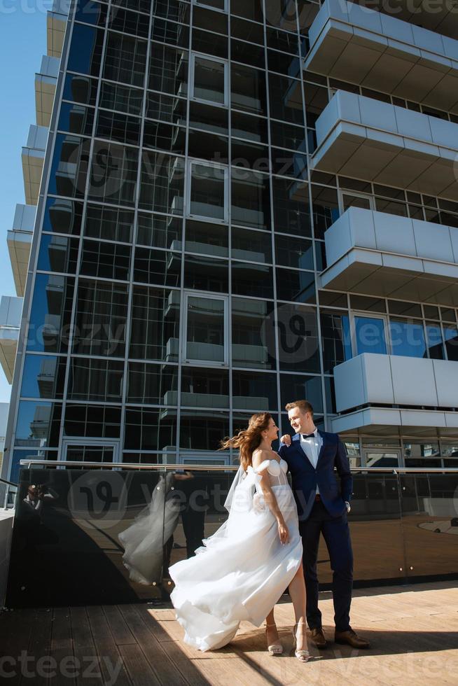 bride and groom first meeting on the roof of skyscraper photo