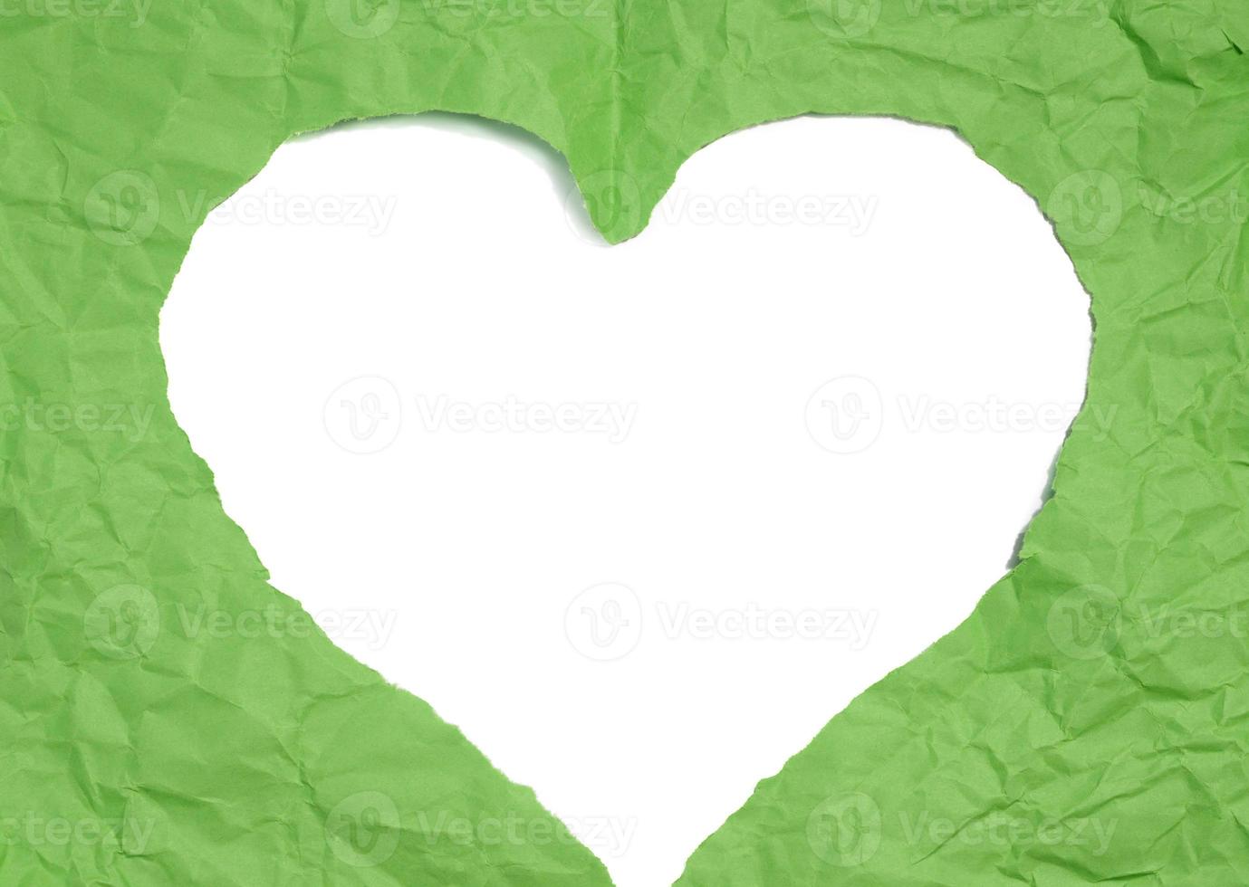 A heart cut out of green paper on a white isolated background, an element for a designer. photo