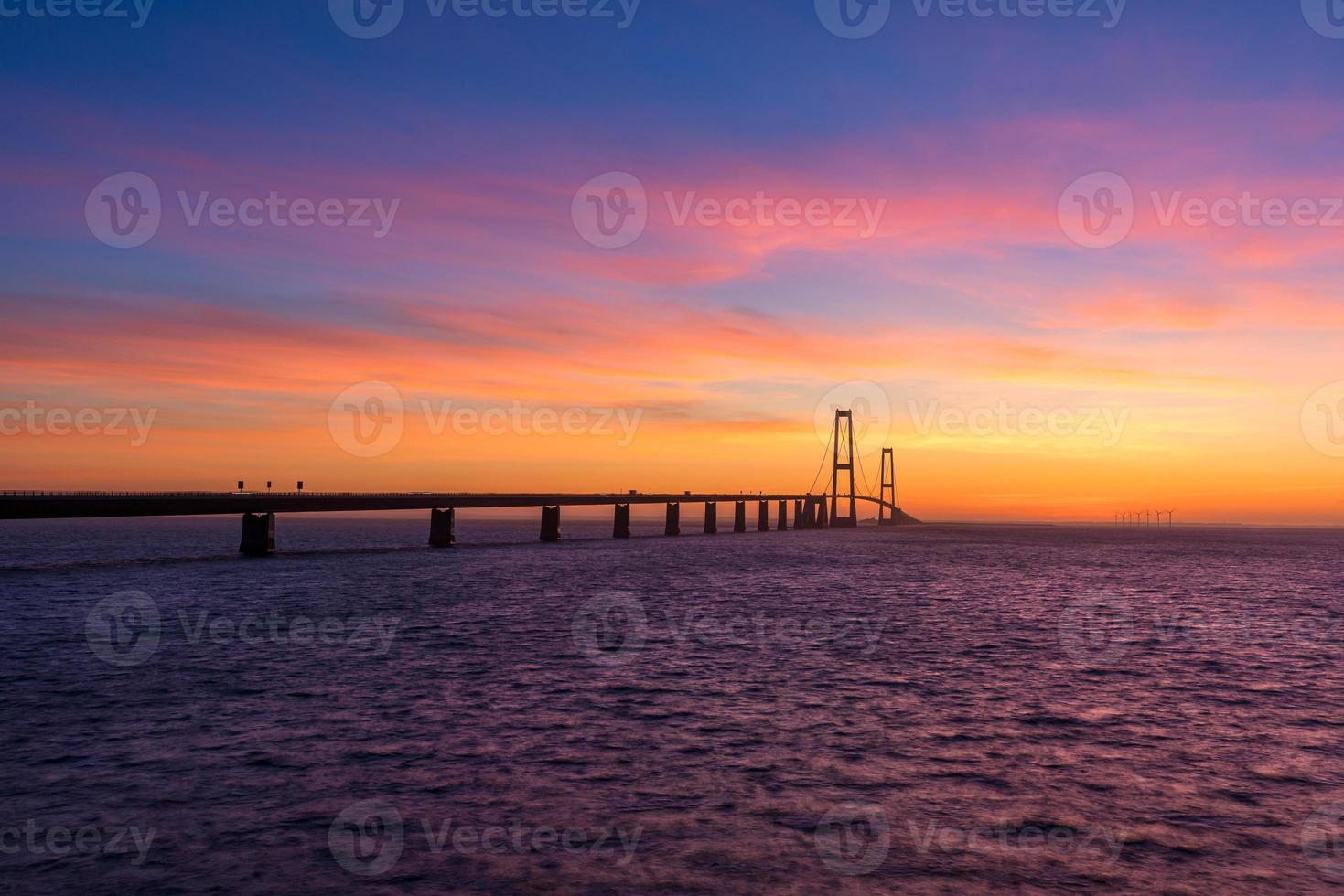 The Great Belt bridge in Denmark during a very colorful sunset photo