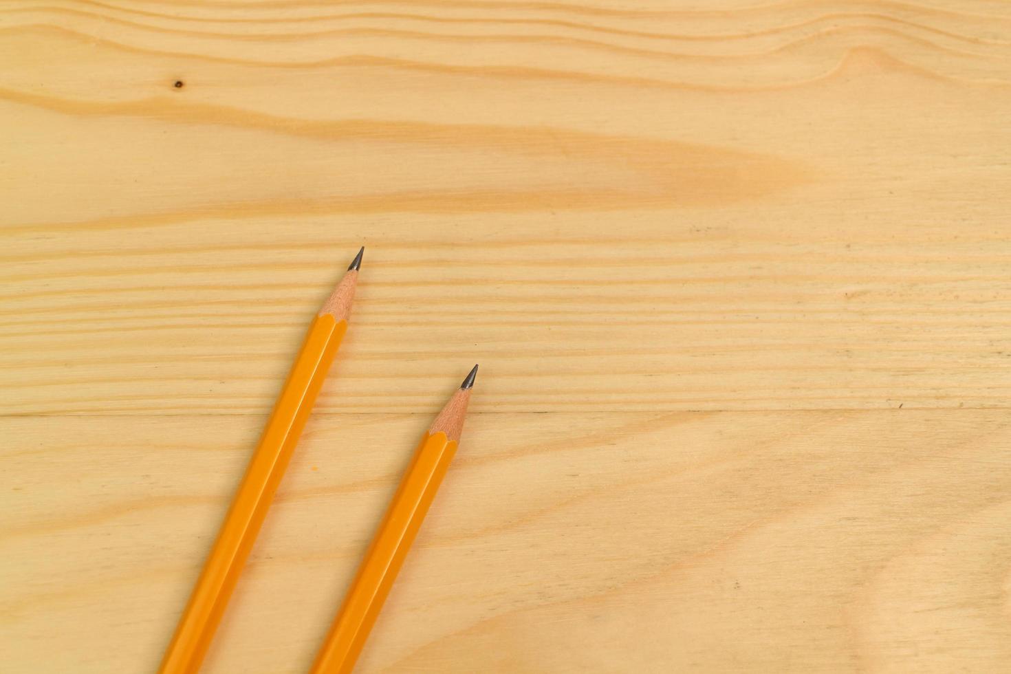 Yellow Pencil on Wooden Background photo