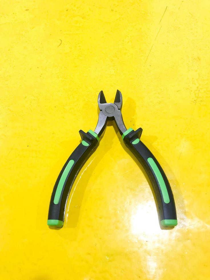 cut pliers isolated yellow background photo