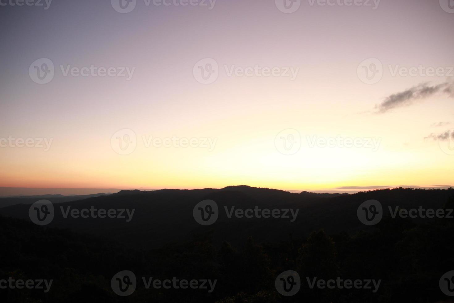 blur sunrise sunset sky view with fog on the top of mountain background photo