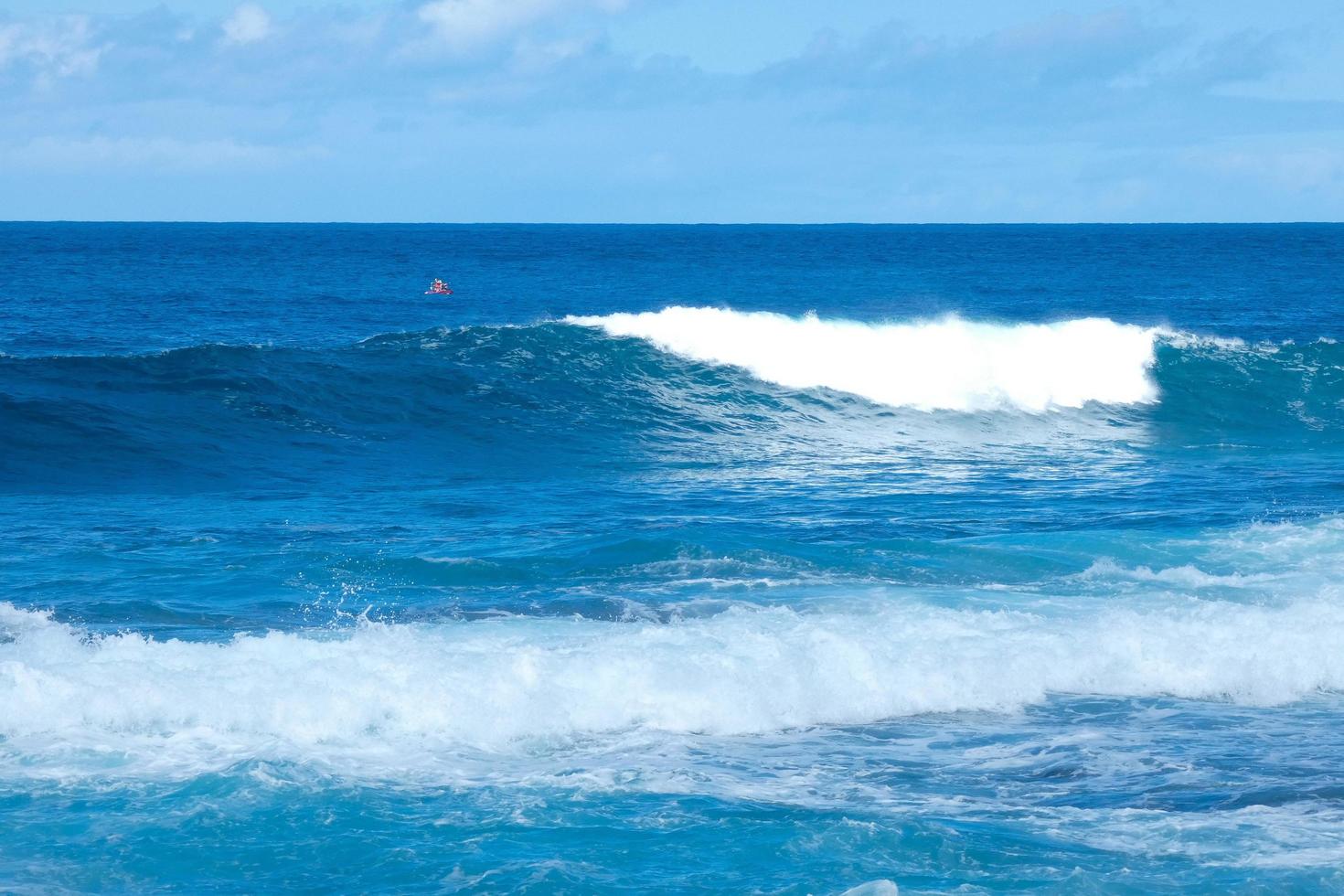 Large waves crashing against the rocks in the ocean photo