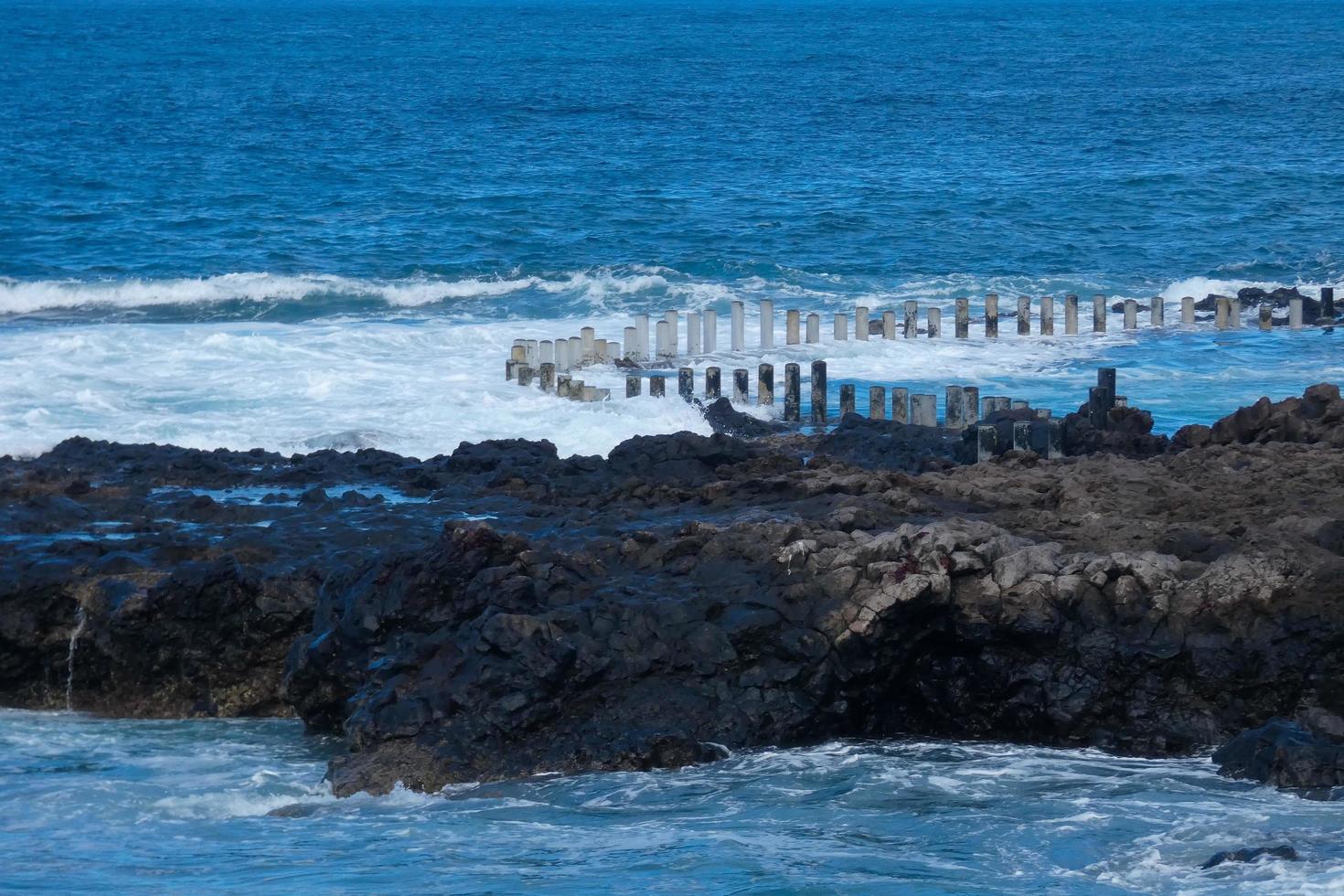 Large waves crashing against the rocks in the ocean photo