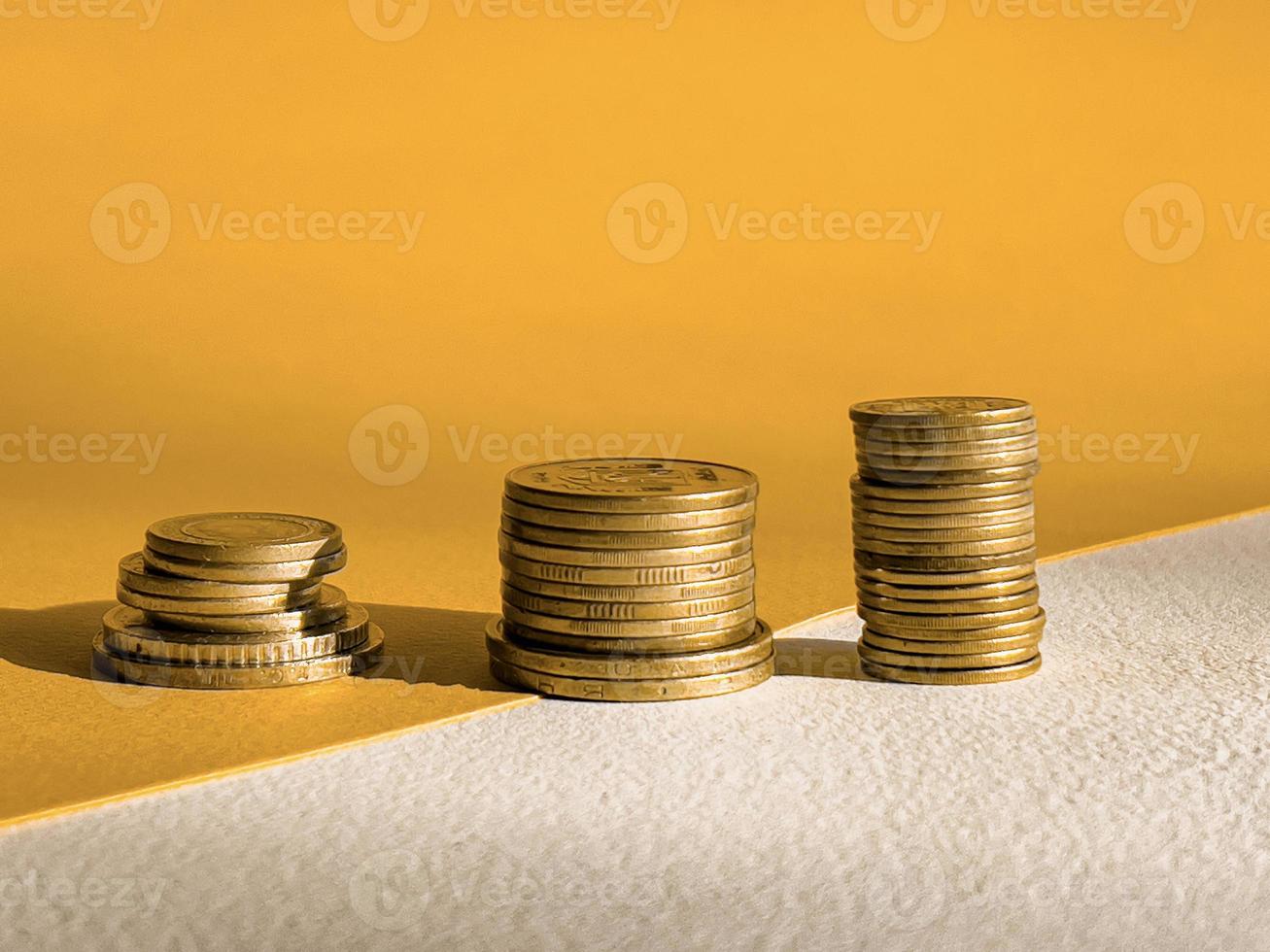 stacks of coins. golden stacks of coins in ascending order photo