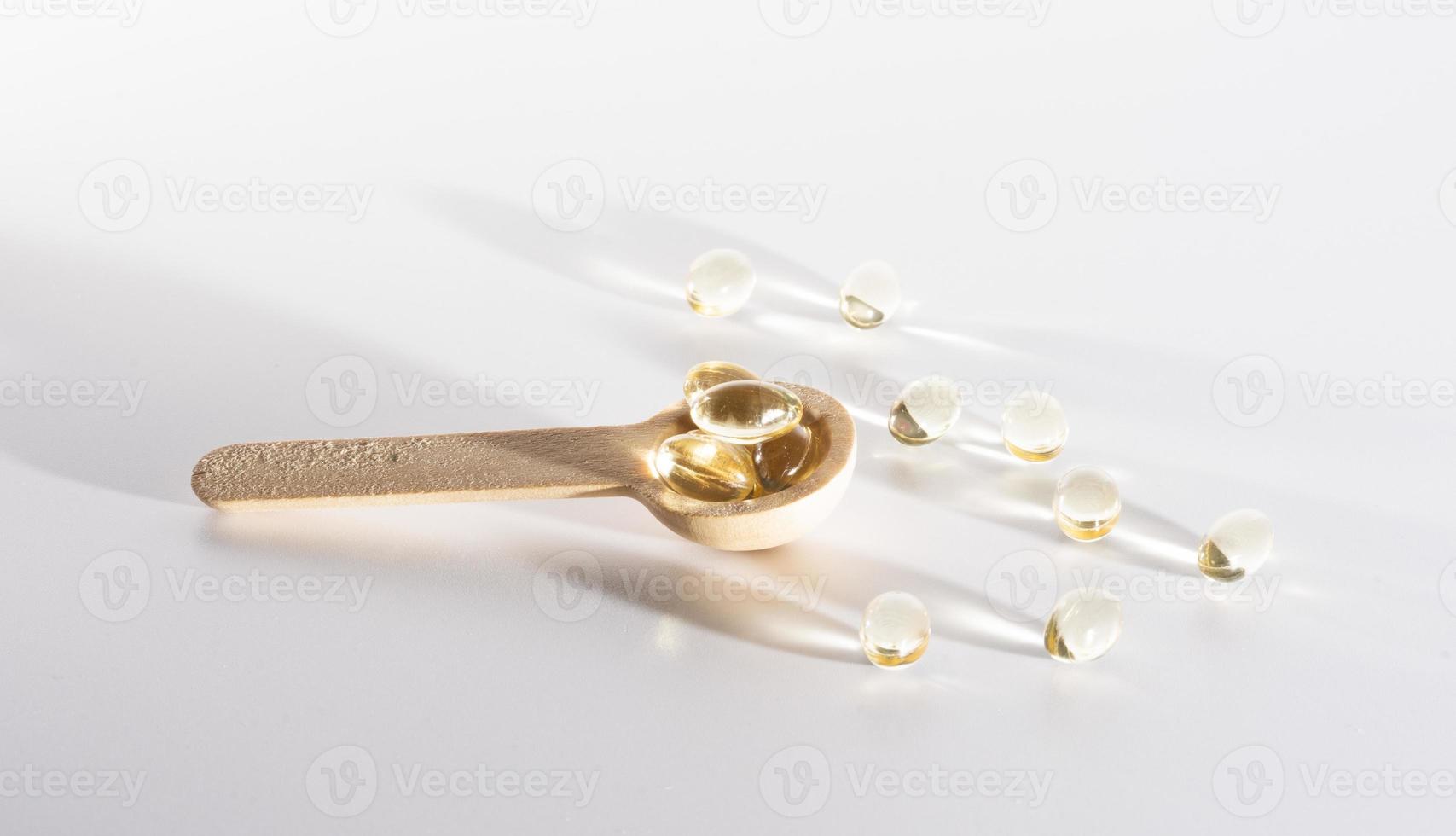 Spoons with vitamins, Vitamin D, omega 3, omega 6, Food supplement oil filled fish oil, vitamin A, vitamin E, flaxseed oil photo