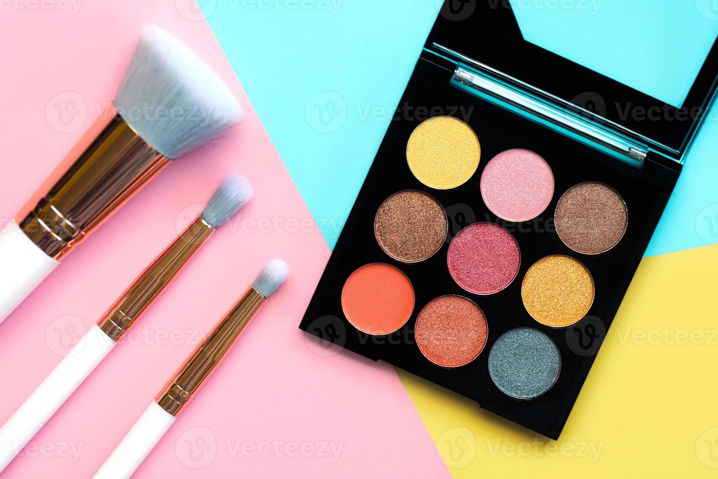 Top view of makeup brushes and eyeshadow and contouring palette. Beauty and makeup concept photo