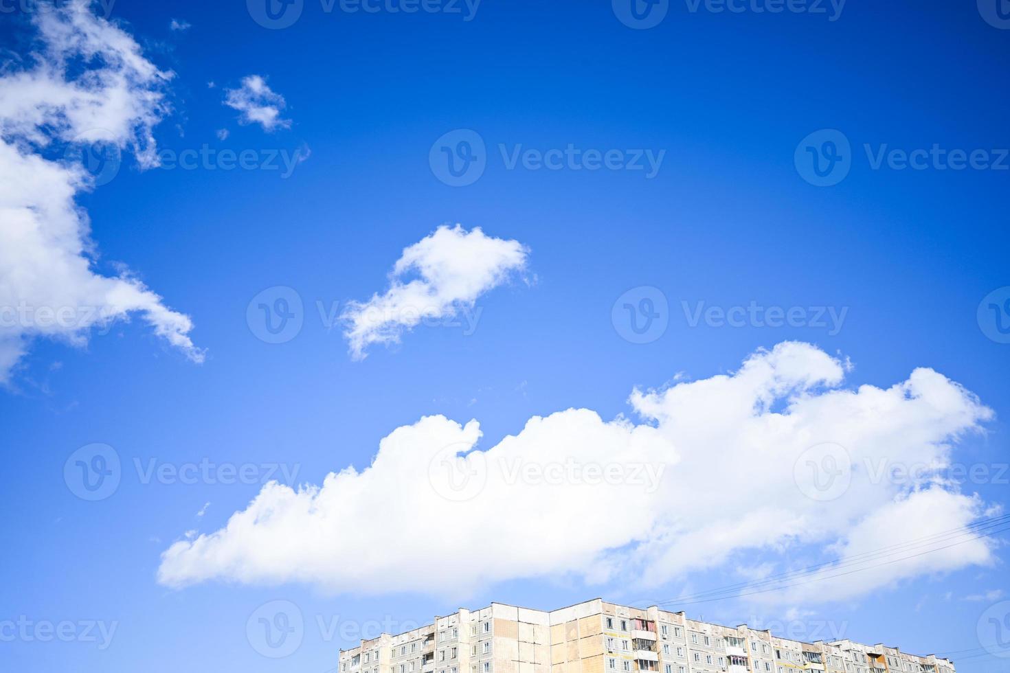 Blue sky with white clouds. Bright sunny day. Cumulus clouds high in the azure sky, beautiful view of the cloudy landscape. photo