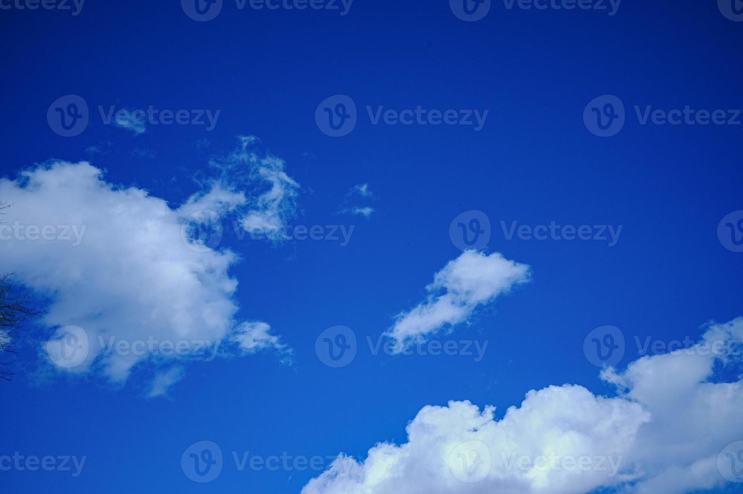 Blue sky with white clouds. Bright sunny day. Cumulus clouds high in the azure sky, beautiful view of the cloudy landscape. photo
