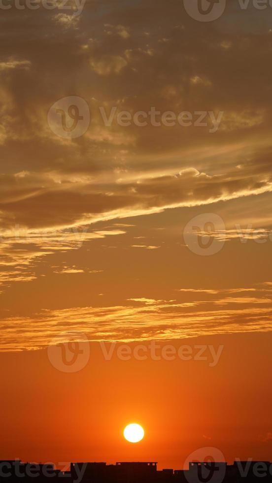 The beautiful sunset sky view with the colorful clouds and warm lights in the sky photo