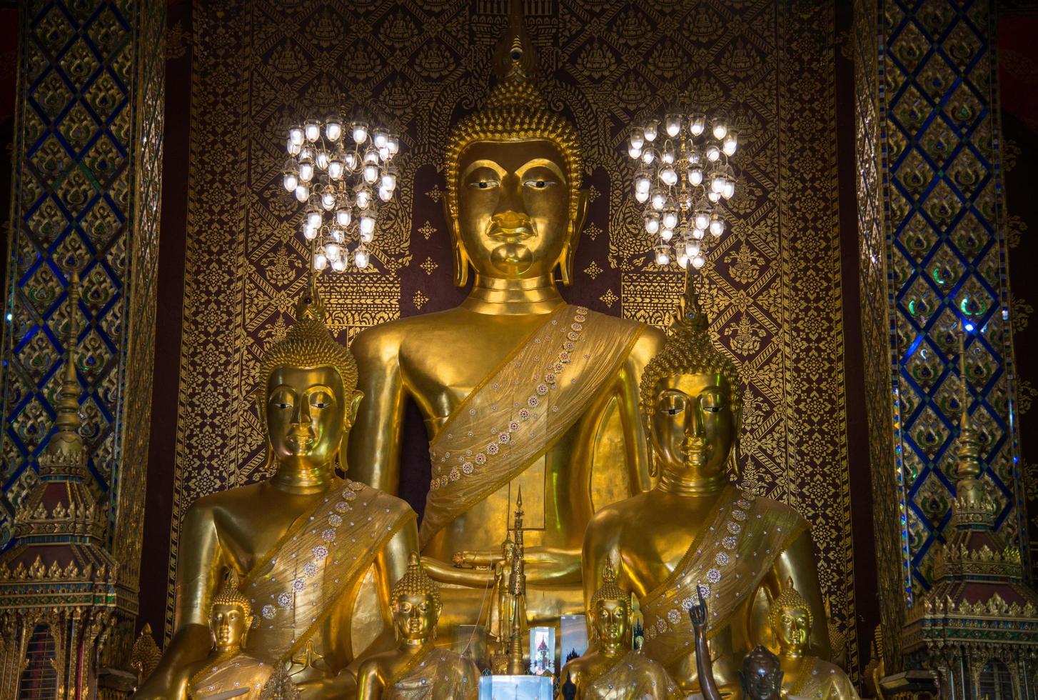 The Buddha statue in viharn of Wat Phra That Hariphunchai the iconic famous temple in Lamphun city, Northern Thailand. photo