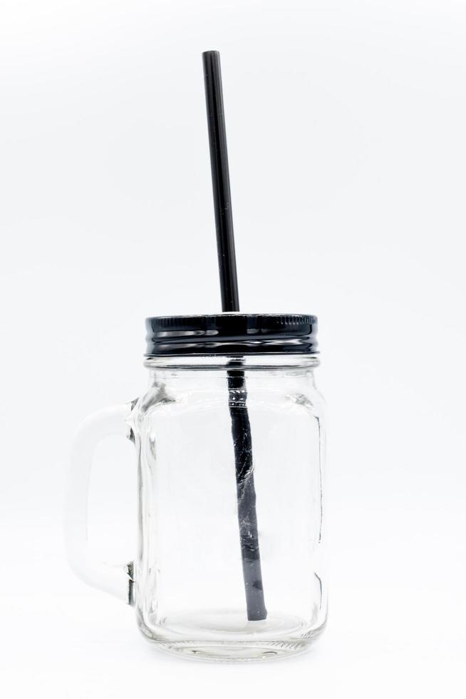 Glass bottle with black cap on isolated white background. photo