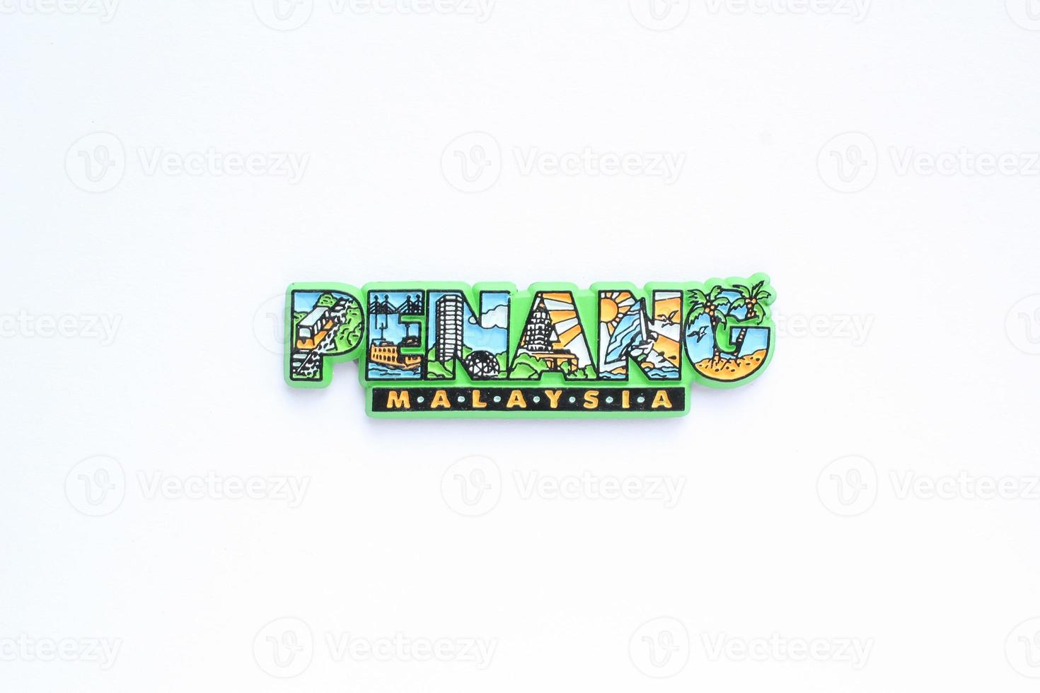 Colourful PVC souvenir fridge magnet of Penang, Malaysia on white background. Travel memory concept. Gift typical product for tourists from foreign trip. Home decoration. Top view, flat lay, close up photo