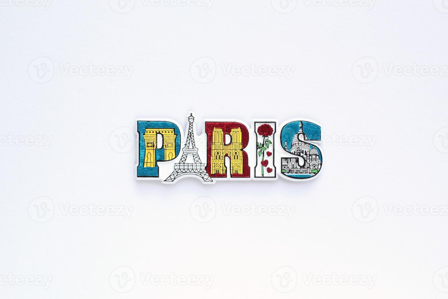 Colourful PVC souvenir fridge magnet of Paris, France on white background. Travel memory concept. Gift typical product for tourists from foreign trip. Home decoration. Top view, flat lay, close up photo