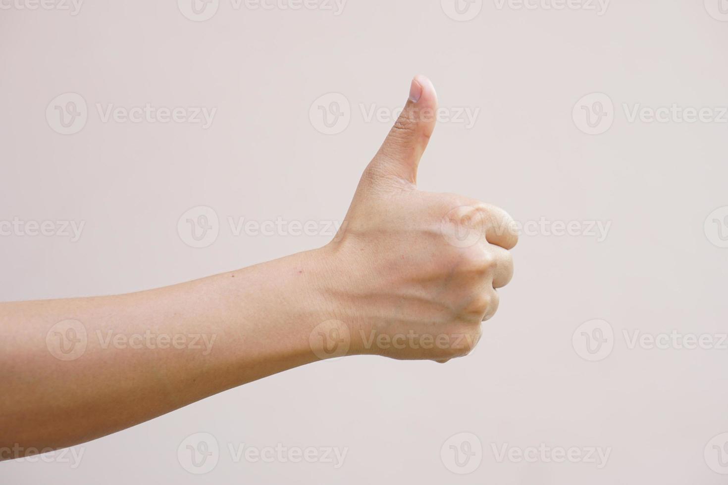 Asian woman raising hand showing great sign photo