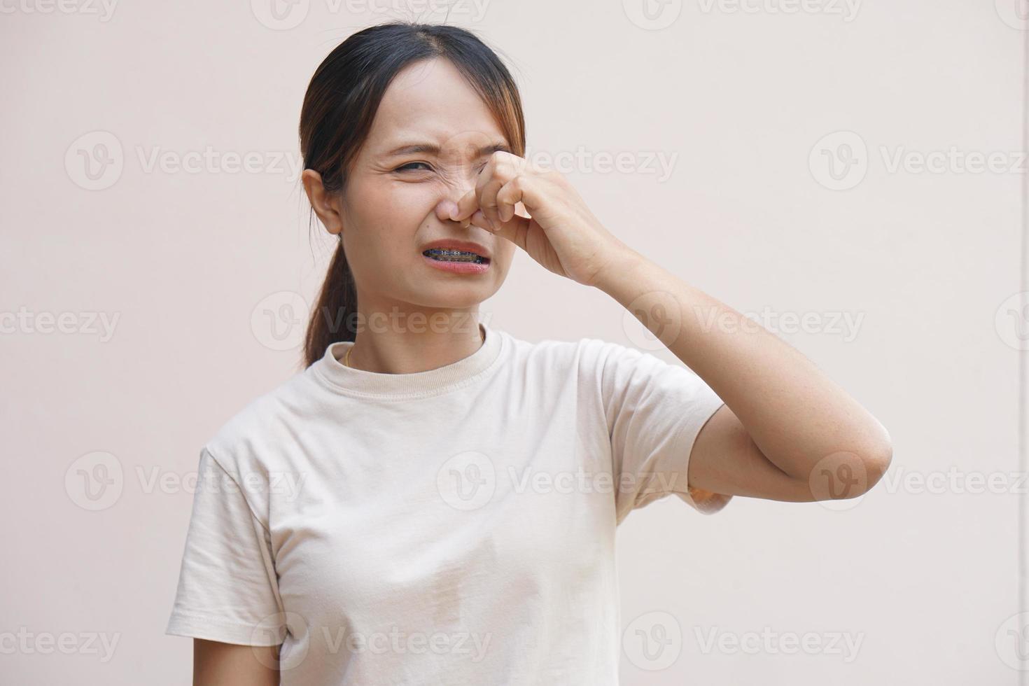 Asian woman having stuffy nose from cold photo